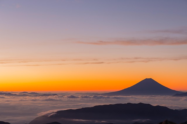 Shinkansen bullet train speeding through countryside cherry blossoms Mount Fuji